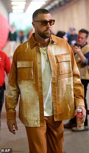 103360073-15232399-Travis_Kelce_opted_for_a_light_brown_matching_set_as_he_entered_-a-24_17616042133.jpeg