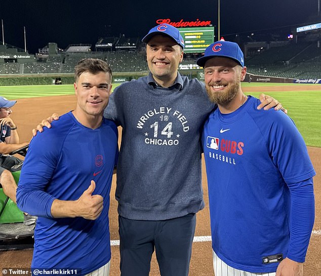 101611063-15461625-Charlie_Kirk_center_is_flanked_by_Cubs_infielders_Matt_Shaw_left-a-11_17683587428.jpeg