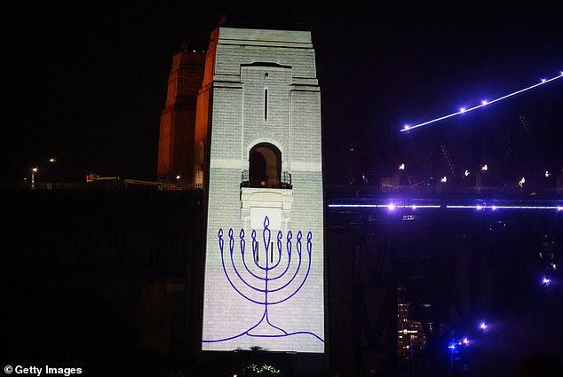 105167009-15427795-An_image_of_a_menorah_is_projected_onto_the_pylons_of_the_Sydney-a-59_17673183464.jpeg