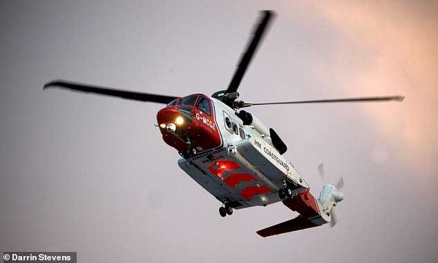 105187987-15430937-The_HM_Coastguard_helicopter_hovers_above_the_sea_as_part_of_the-a-20_17674351480.jpeg