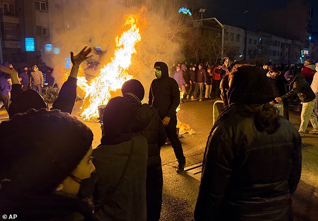 105497147-15462263-Iranians_attend_an_anti_government_protest_in_Tehran_Iran_Friday-a-105_1768384442.jpeg