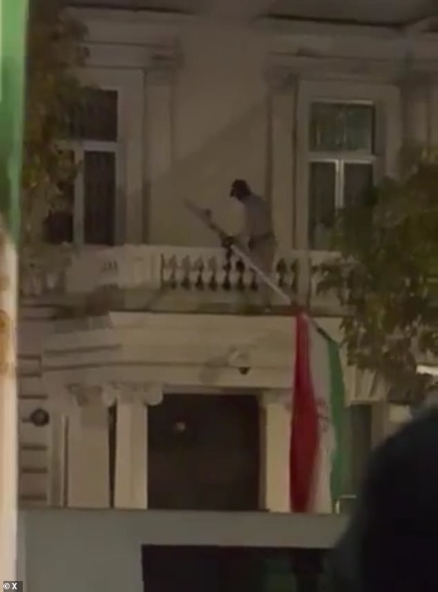 105588507-15472619-A_separate_video_shows_the_activist_removing_the_Iranian_flag_fr-a-2_176864856487.jpeg