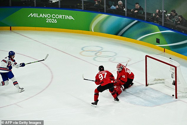 106582395-15582459-Jack_Hughes_scores_the_historic_golden_goal_as_USA_beat_Canada_f-a-1_177182291874.jpeg