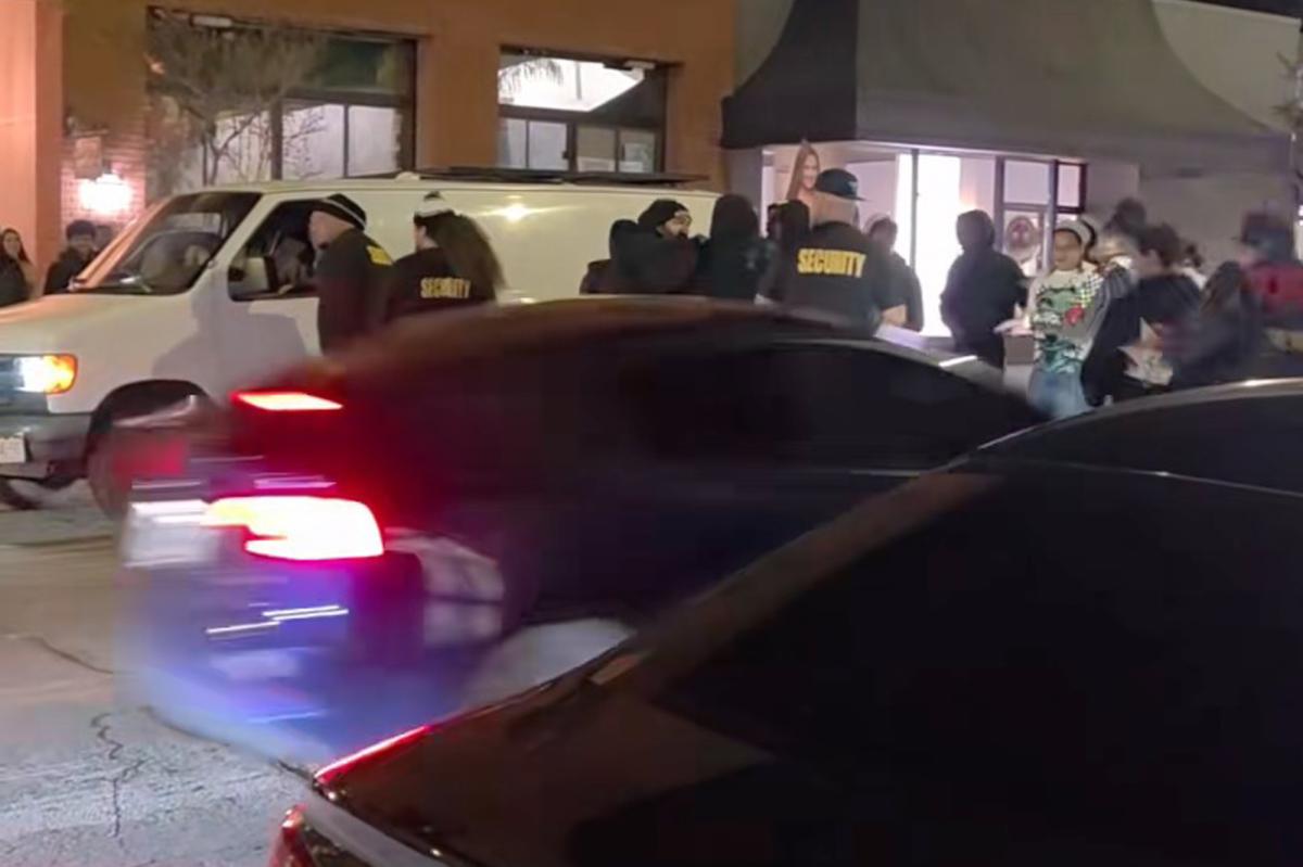 7609926007012822302-car-barrels-crowd-outside-122165159.jpg