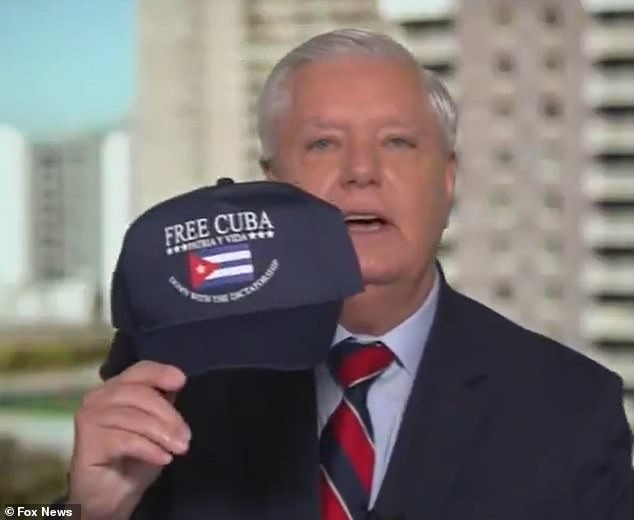 106969359-15626495-Senator_Lindsey_Graham_lifted_a_navy_blue_hat_with_the_Cuban_fla-m-3_177299541423.jpeg